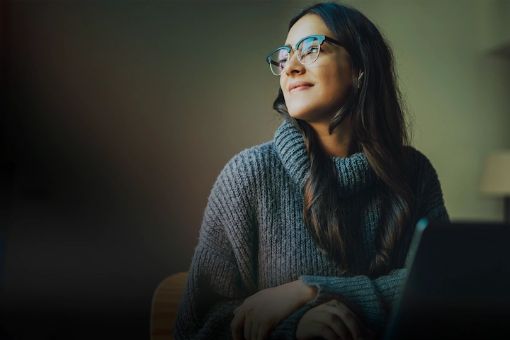 Person smiling while looking distantly